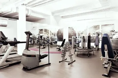 a gym with cardio equipment and treadmills at Newstar Hotel (Free Parking) in St. Gallen