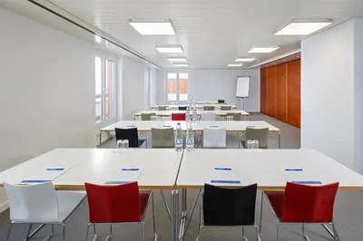 a large conference room with tables and chairs at Newstar Hotel (Free Parking) in St. Gallen