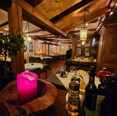 a restaurant with a table with bottles of wine at Hotel Taverne zur Linde in Bischofszell