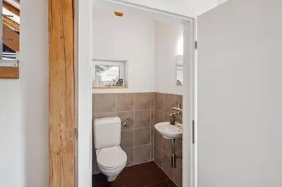 a bathroom with a toilet and a sink at FENUS Grabs Gemütliche Ferienwohnung SGT06 in Grabs