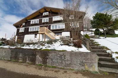 a house with snow on the ground in front of it at Nuessli in Wildhaus