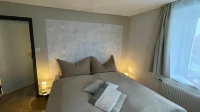 a bedroom with a bed with two pillows on it at Ferienwohnung Edelweiss in Wolfhalden