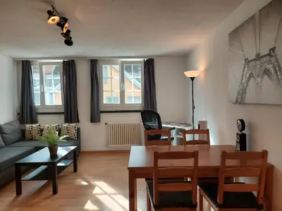 a living room with a table and a couch at Global Citizen 5 in St. Gallen