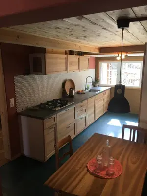 a kitchen with a wooden table and a wooden table sidx sidx sidx at Farbige Wohnung Zentral in Herisau