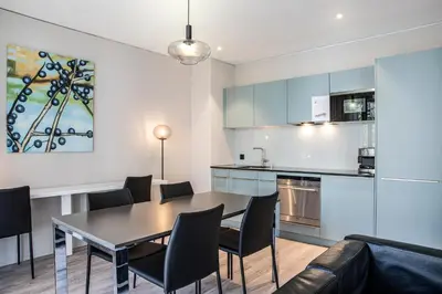 a kitchen and dining room with a table and chairs at VISIONAPARTMENTS St Gallen - contactless check-in in St. Gallen