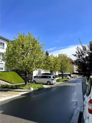 a street with a car parked on the side of the road at Sonniges Bodensee-Balkonidyll in Arbon