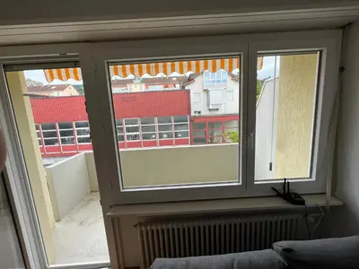 a living room with a gray couch and a coffee table at Ferienwohnung am Bodensee in Rorschach