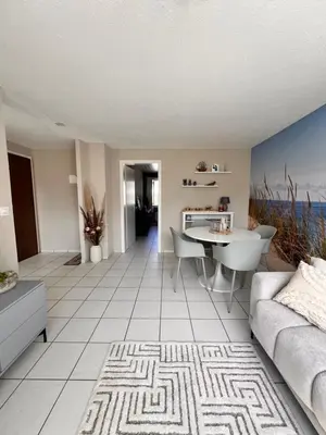 a living room with a couch and a table at Ferienwohnung SUN SAND SEA in Horn