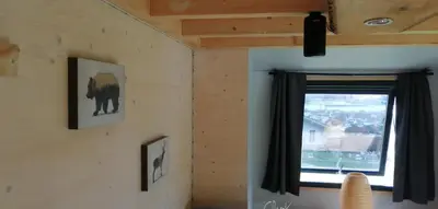 a room with a window and a picture of a bear at Tiny House im Grünen in Sankt Margrethen