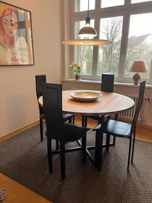 a dining room table and chairs in a room at Charmante Jugendstilwohnung mit Tiefengaragenplatz in St. Gallen