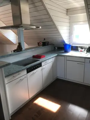 a kitchen with white cabinets and a sink at Ferienwohnung zentrale ruhige Lage auch gerne mit Kindern in Arbon