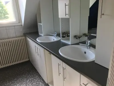 a bathroom with two sinks and a mirror at Ferienwohnung zentrale ruhige Lage auch gerne mit Kindern in Arbon