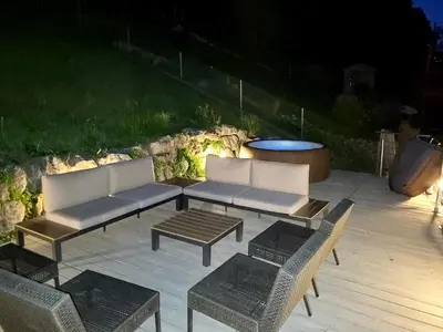 a patio with two couches and a table and chairs at Chalet Wahida- Wellness Oase im Neckertal! in Sankt Peterzell