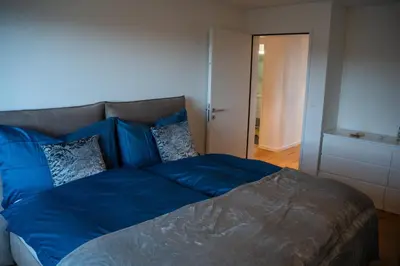a white closet with white cabinets and hangers at Seenähe 300 Meter 126 qm Wohnfläche 6 Betten in Rorschacherberg