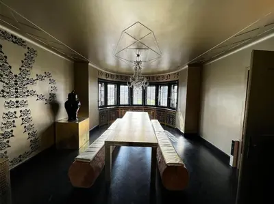a long bench in a room with a chandelier at VILLA Philipp Plein - Designervilla mit Pool & SPA in Amriswil