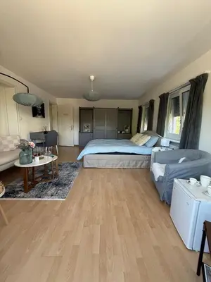 a bedroom with a bed and a living room at MTL Schweiz Apartments in Kreuzlingen
