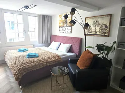 a small bedroom with a bed and a couch at Ferien Studio Wohnung Altstadt Multergasse 20 in St. Gallen