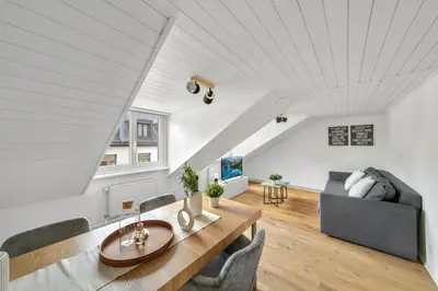 a living room with a table and a couch at book2stay moderne Wohnung OLMA-Areal in St. Gallen