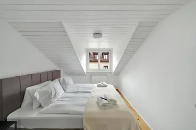 a bedroom with a bed with towels on it at book2stay moderne Wohnung OLMA-Areal in St. Gallen