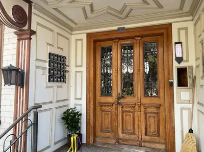 a wooden door with glass panels on a building at 11 - Gästehaus Erika - Hundwil - Appenzellerland in Hundwil