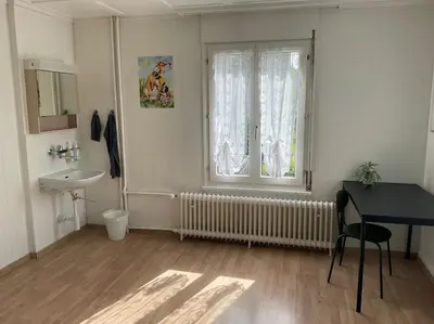 a bathroom with a sink and a window and a desk at 02 - Gästehaus Erika - Hundwil - Appenzellerland in Hundwil