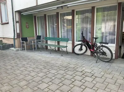 a bike parked next to a bench and a table at 07 - Gästehaus Erika - Hundwil - Appenzellerland in Hundwil