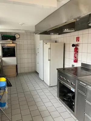 a kitchen with a refrigerator and a stove at 08 - Gästehaus Erika - Hundwil - Appenzellerland in Hundwil