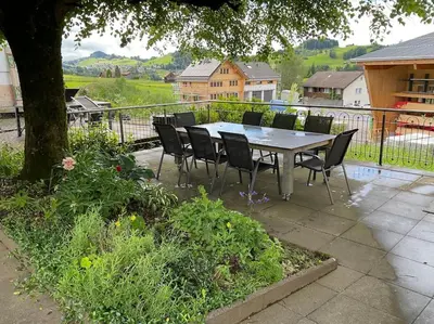 a table and chairs sitting on a patio at 12 - Gästehaus Erika - Hundwil - Appenzellerland in Hundwil