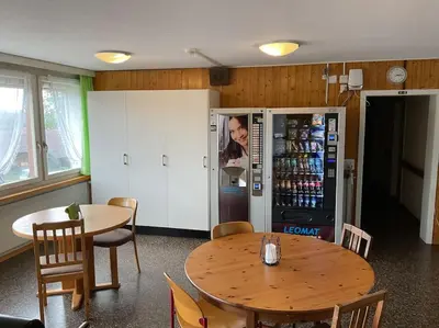 a dining room with a table and a refrigerator at 12 - Gästehaus Erika - Hundwil - Appenzellerland in Hundwil