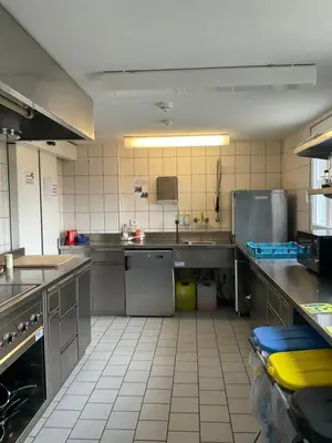 a large kitchen with stainless steel counters and appliances at 15 - Gästehaus Erika - Hundwil - Appenzellerland in Hundwil