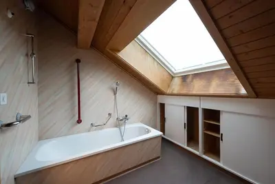 a bathroom with a large bath tub and a skylight at 17 - Gästehaus Erika - Hundwil - Appenzellerland in Hundwil