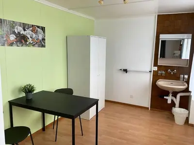 a bathroom with a black table and a sink at 19 - Gästehaus Erika - Hundwil - Appenzellerland in Hundwil