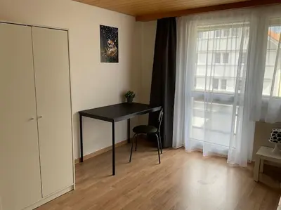 a black desk in a room with a window at 24 - Gästehaus Erika - Hundwil - Appenzellerland in Hundwil