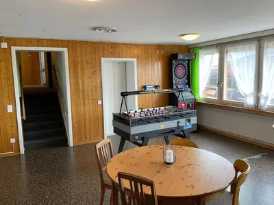 a room with a table and a table and a table and chairs at 25 - Gästehaus Erika - Hundwil - Appenzellerland in Hundwil