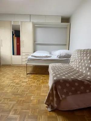 a bedroom with two beds and a wooden floor at Wildhaus Ferienwohnung in Wildhaus