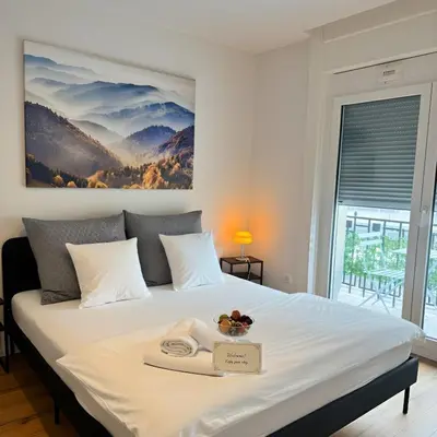 a bedroom with a bed with a tray of food on it at Zentrales Apartment St Gallen an der Olma in St. Gallen