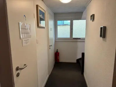 an office hallway with a door and a window at Altstadt Gästehaus in Arbon