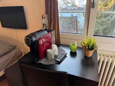 a desk with a coffee maker on top of it at Altstadt Gästehaus in Arbon
