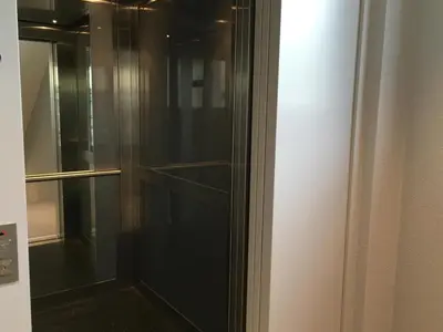 a glass door of a refrigerator in a room at Hotel Flawil in Flawil