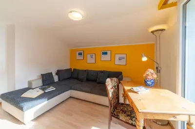 a living room with a couch and a table at Fuechsle in Wildhaus