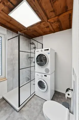 a bathroom with a washing machine and a shower at FENUS SGT10 Panoramaview Parking Kitchen in Grabs