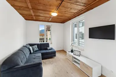 a living room with a couch and a flat screen tv at FENUS SGT10 Panoramaview Parking Kitchen in Grabs