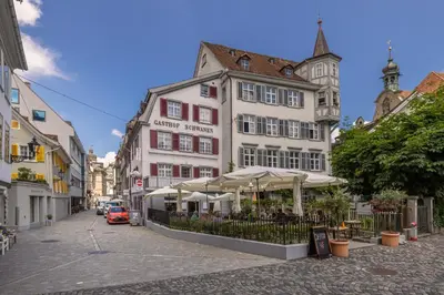 a bedroom with a large bed and a window at Ferienwohnungen Webergasse 23 in St. Gallen
