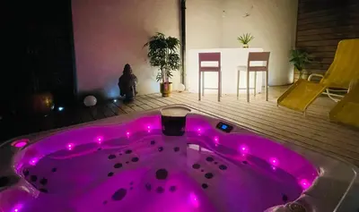 a hot pink bath tub with pink lights in a room at Private SPA Seeliebe - Ihre Ruheoase in Amriswil