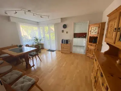 a large living room with a table and a kitchen at 3 Zimmer-Ferienwohnung in der Rüti in Herisau
