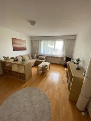 a living room with a couch and a table at 3 Zimmer-Ferienwohnung in der Rüti in Herisau