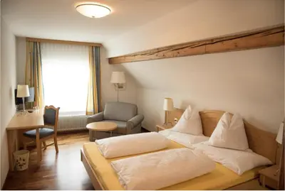 a hotel room with a bed and a chair at Haus Engel Gams in Gams