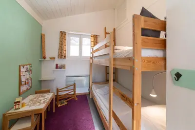 a room with two bunk beds and a desk at Eldanora in Wildhaus