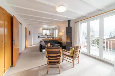 a living room with a couch and a table and chairs at Eldanora in Wildhaus