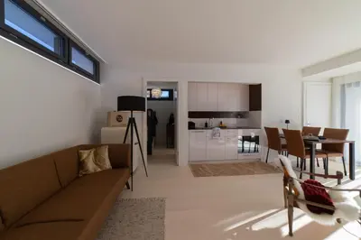 a living room with a couch and a dining room at Alpstein in Wildhaus